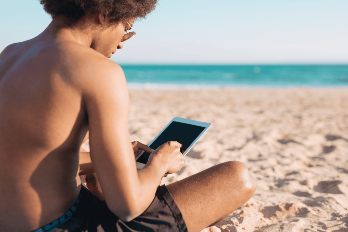 A person on the beach checking mobile