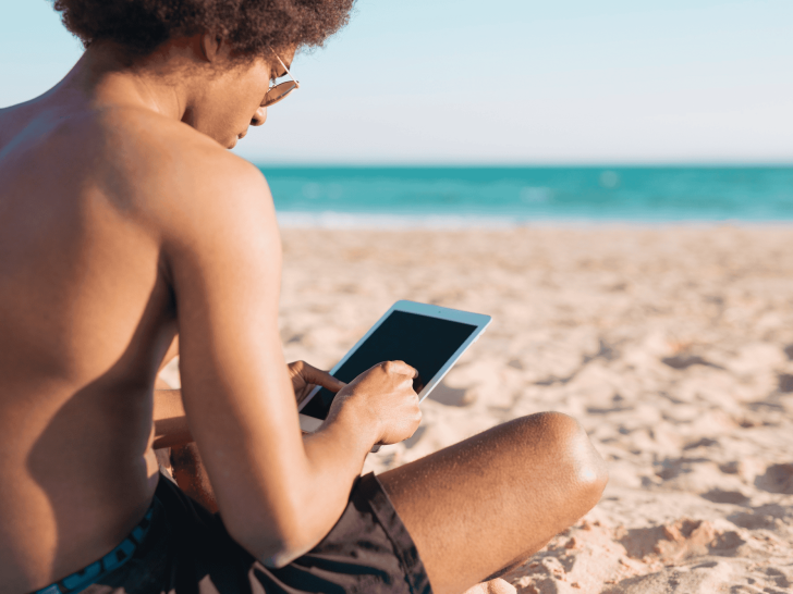 A person on the beach checking mobile